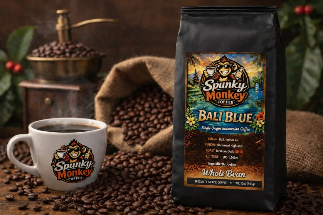 Spunky Monkey Coffee Bali Blue whole bean bag, steaming mug with logo, coffee grinder, beans.